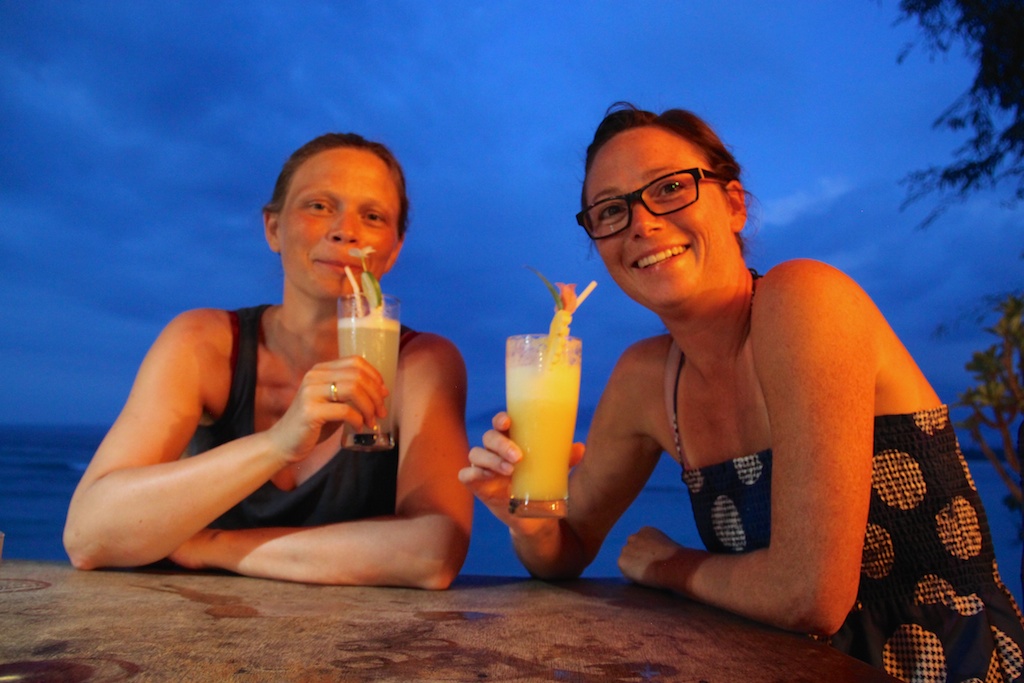 Tove og Helene med drinks på stranden